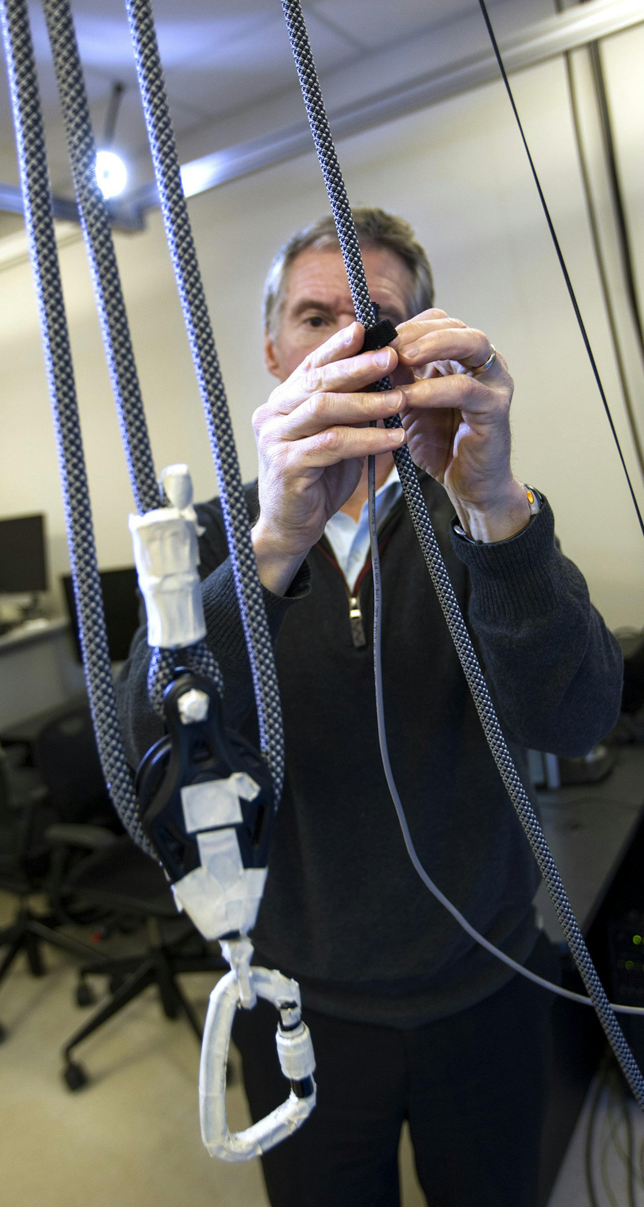 Dr. Colum MacKinnon secures a belay rope that is used for safety purposes when testing a patient's gait in the Movement Disorders Laboratory at the University of Minnesota in Minneapolis April 25, 2014. (Courtney Perry/Special to the Star Tribune)