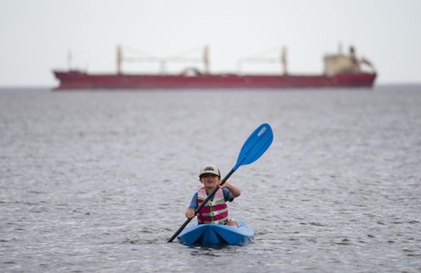 Max Halverson (5) paddled his kayak on Lake Superior off the shore of Park Point beach on Tuesday as he enjoyed the 84 degree weather in Duluth, MN. ] ALEX KORMANN • alex.kormann@startribune.com Temperatures in Duluth, MN hit 84 degrees on Tuesday June 2, 2020. Locals took advantage of the hottest day of the year thus far by hitting Park Point beach in large numbers.