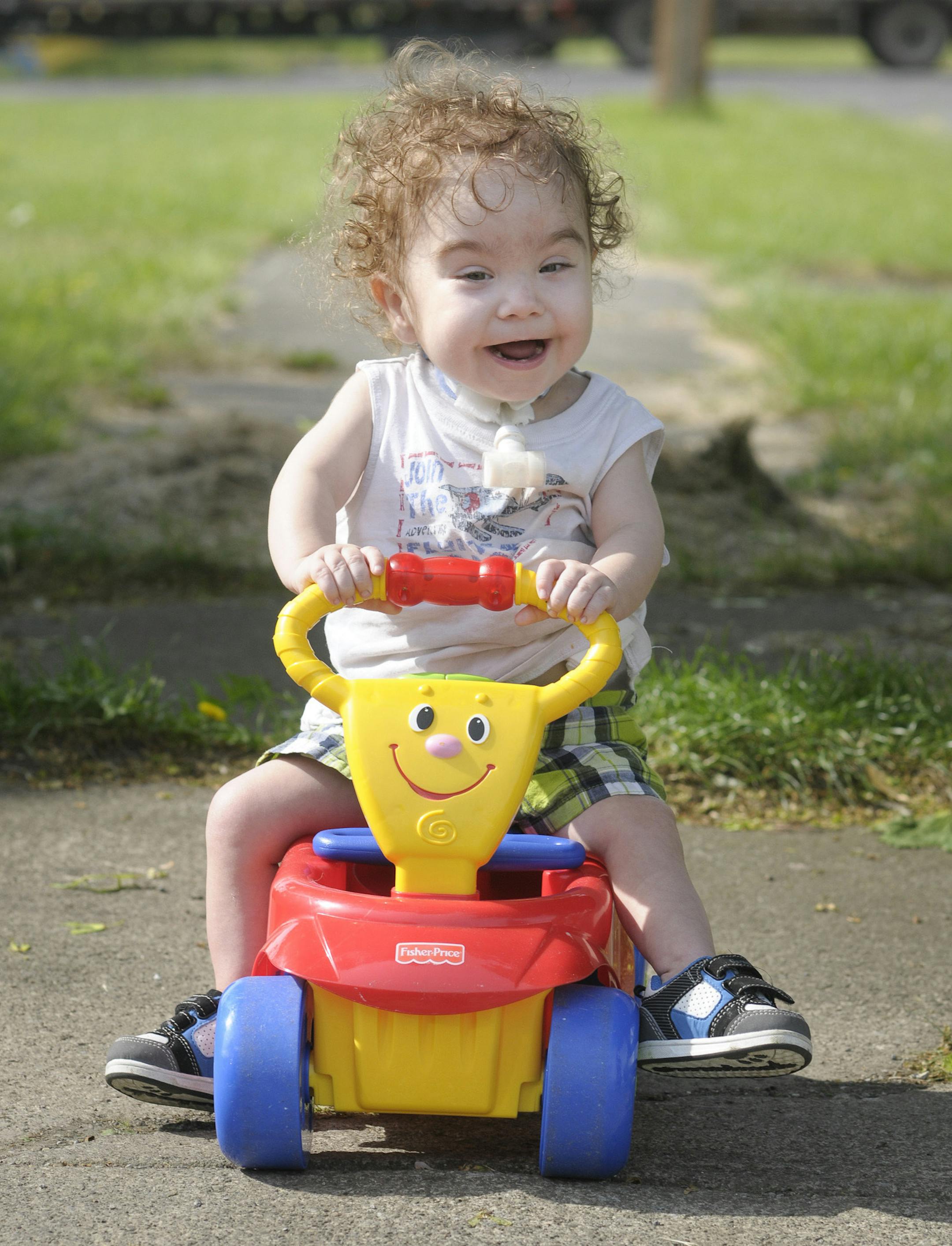 Kaiba Gionfriddo plays outside his Youngstown, Ohio home Tuesday, May 21, 2013. Born with a birth defect that caused the boy to stop breathing every day, he can now breathe normally, with a first-of-a-kind biodegradable airway made by Michigan doctors using plastic particles and a 3-D laser printer. (AP Photo/Mark Stahl)