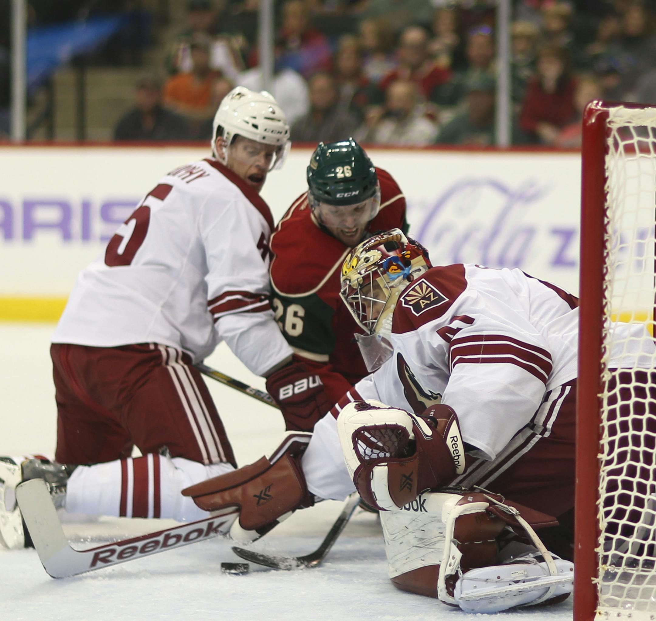 Minnesota Wild left wing Thomas Vanek (26) tried to get his stick on the loose puck in front of Coyotes goalie Mike Smith (41) as he was defended by Arizona defenseman Connor Murphy (5) in the first period Thursday night at Xcel Energy Center. ] JEFF WHEELER ‚Ä¢ jeff.wheeler@startribune.com The Minnesota Wild took on the Arizona Coyotes in an NHL game Thursday night, October 23, 2014 at Xcel Energy Center in St. Paul.