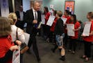 Superintendent Joe Gothard made his way past members of the St. Paul teachers union, wearing their signature red shirts, at a demonstration outside Tu