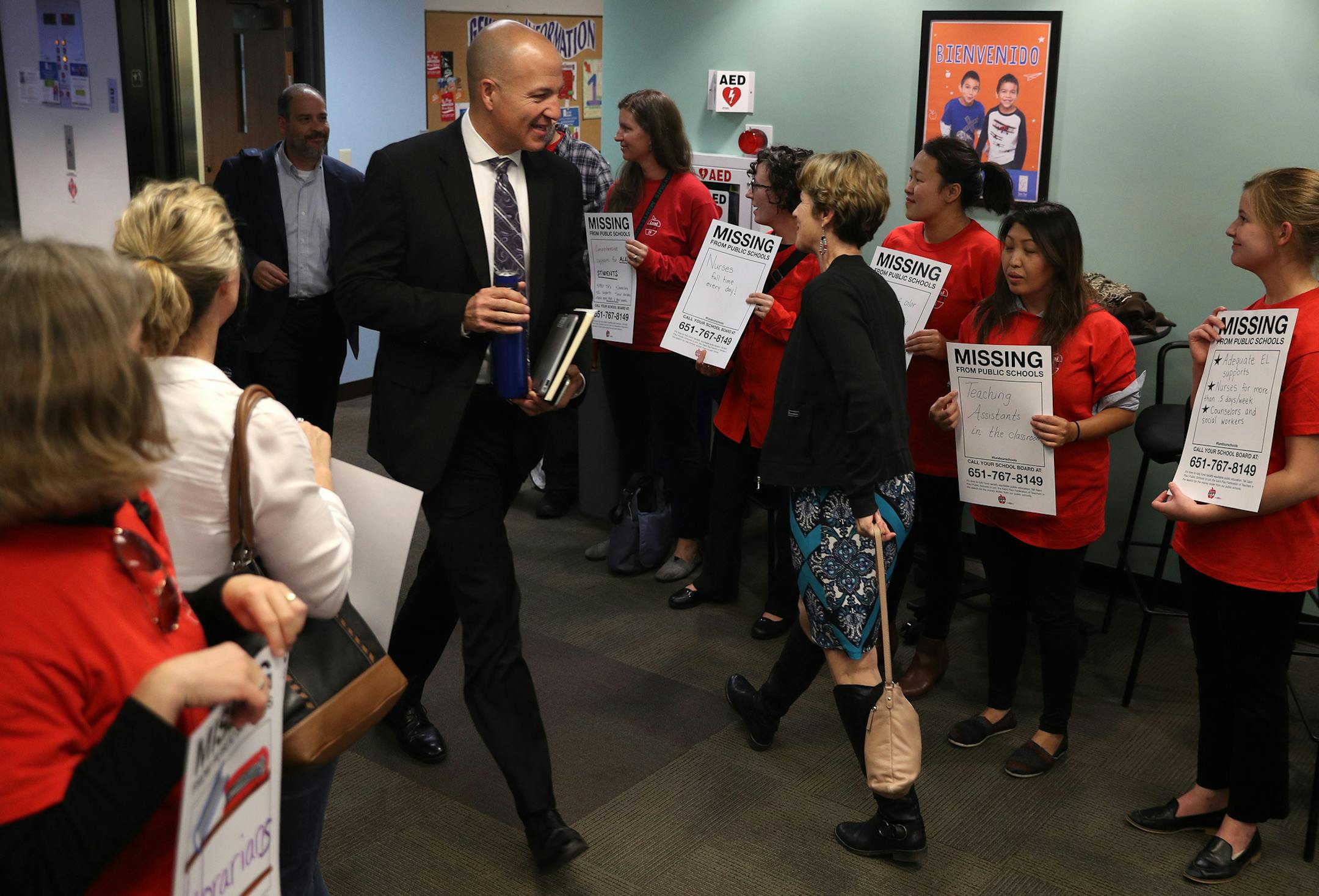 Superintendent Joe Gothard made his way past members of the St. Paul teachers union, wearing their signature red shirts, at a demonstration outside Tuesday's school board meeting. They want the district to put a tax-levy proposal on the November 2018 ballot.