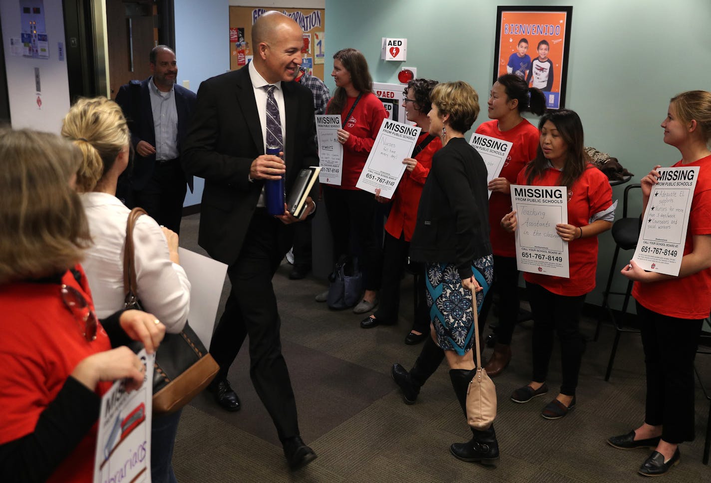 Superintendent Joe Gothard made his way past members of the St. Paul teachers union, wearing their signature red shirts, at a demonstration outside Tuesday's school board meeting. They want the district to put a tax-levy proposal on the November 2018 ballot.