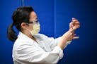Dr. Sophia Kim, an internist at North Memorial, drew a dose of the Pfizer BioNTech COVID-19 vaccine with a syringe Monday morning.