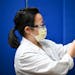 Dr. Sophia Kim, an internist at North Memorial, drew a dose of the Pfizer BioNTech COVID-19 vaccine with a syringe Monday morning.