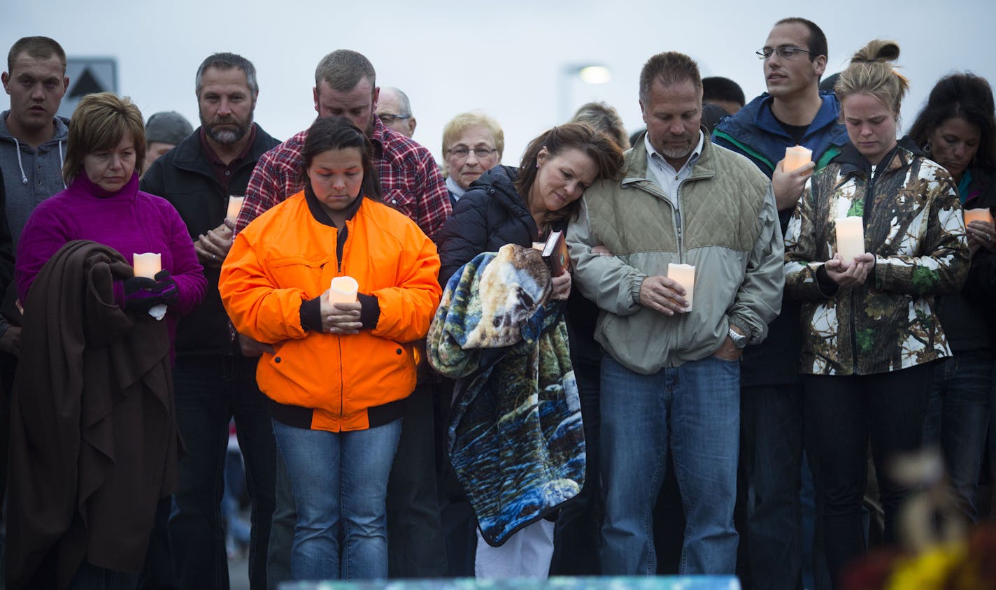 Family members including sister Katelyn, mother Patty, father Randy and sister Heather, were emotional during a song during a candlelight vigil for their loved one Joseph Brunn whose body was discovered earlier in day in the Mississippi River on Thursday October 8, 2015, outside the Holiday Inn in Otsego, Minn.,. ] RENEE JONES SCHNEIDER &#x2022; reneejones@startribune.com family in left to right starting with Katelyn in blaze orange. Dont know sisters' lastnames.