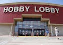 FILE - This June 30, 2014, file photo shows customers walking into a Hobby Lobby store in Oklahoma City. There may be more to that "we the people" not