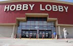 FILE - This June 30, 2014, file photo shows customers walking into a Hobby Lobby store in Oklahoma City. There may be more to that "we the people" not