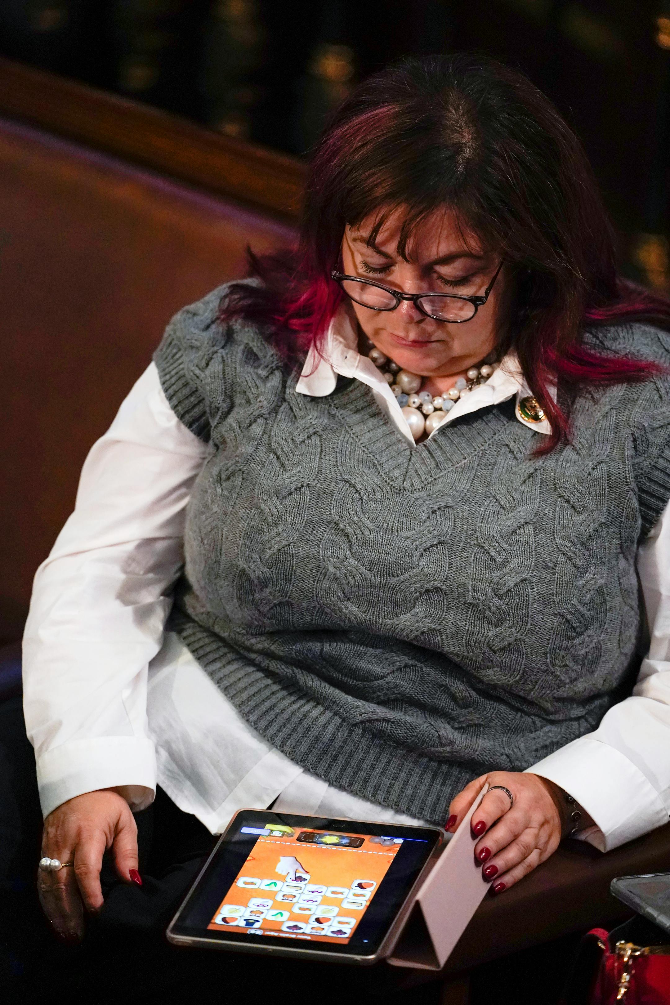 Rep. Linda Sanchez, D-Calif., plays a game before the start of the ninth vote in the House chamber as the House meets for the third day to elect a speaker and convene the 118th Congress in Washington, Thursday, Jan. 5, 2023. (AP Photo/Alex Brandon)