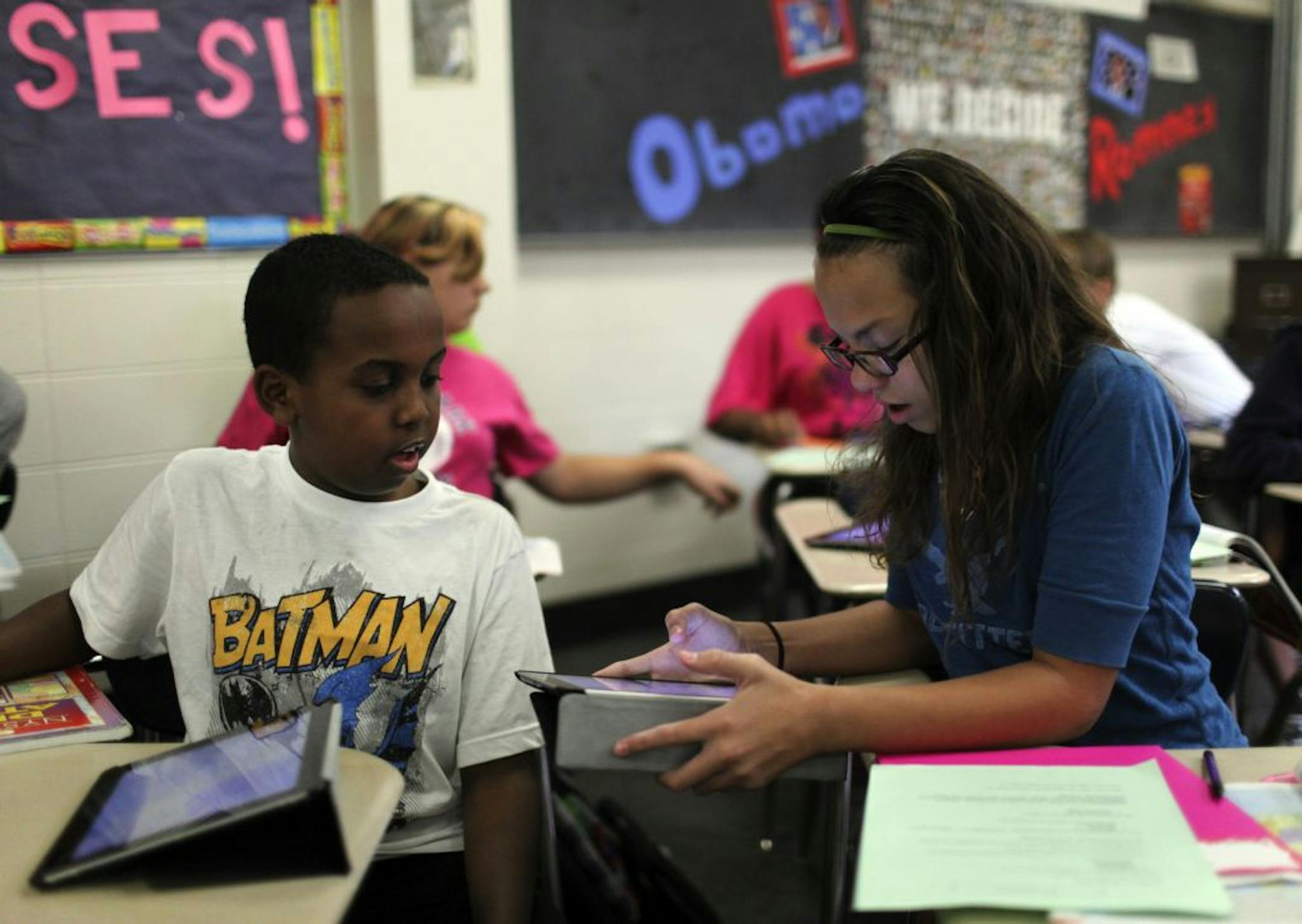 Students in Kim Campbell's seventh grade social studies class used an iPad to work on a mapping exercise Tuesday, Sept. 11, 2012 at West Junior High in Minnetonka , MN. Here, Yasin Abdi, left to right, and Jazmine Dunn, helped each other out with an iPad mapping exercise.