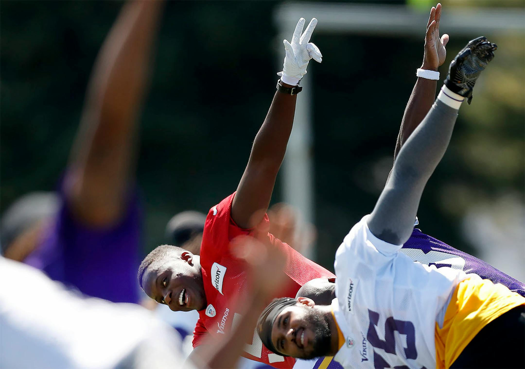 Minnesota Vikings quarterback Teddy Bridgewater (5) and Anthony Barr stretched out during the afternoon practice on the first day of training camp in Mankato.