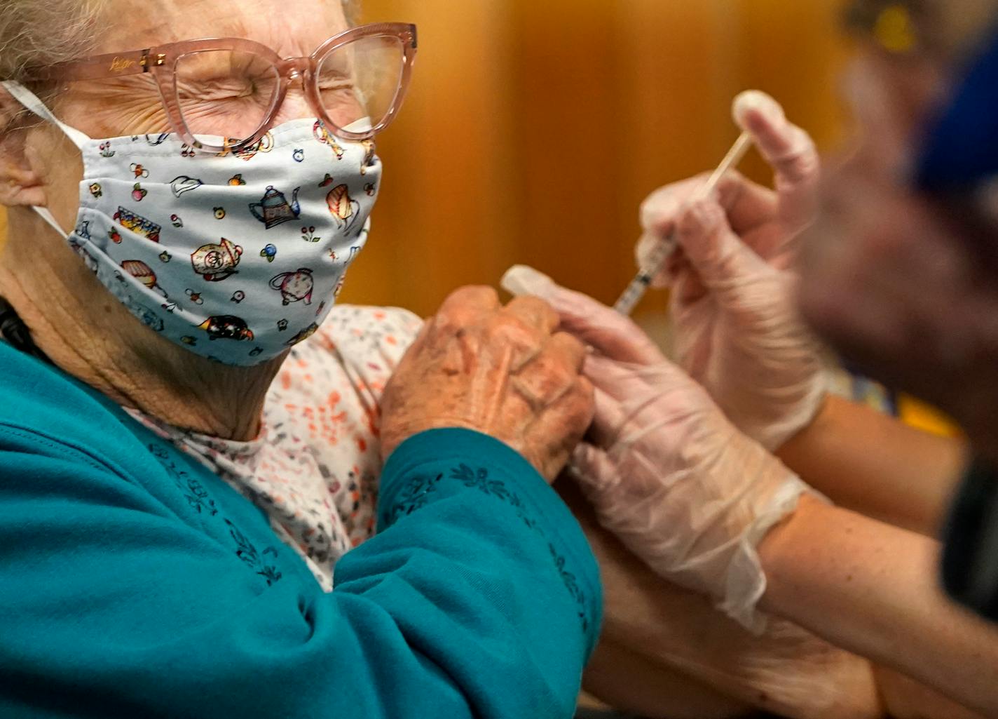 Resident Arlene Studerman was among 200 elderly residents and workers who received the first of two Moderna vaccinations at the Oak Meadows Senior Living complex Thursday in Oakdale. Giving Studerman her vaccination was Walgreen's pharmacist Kelli Johnson. ]