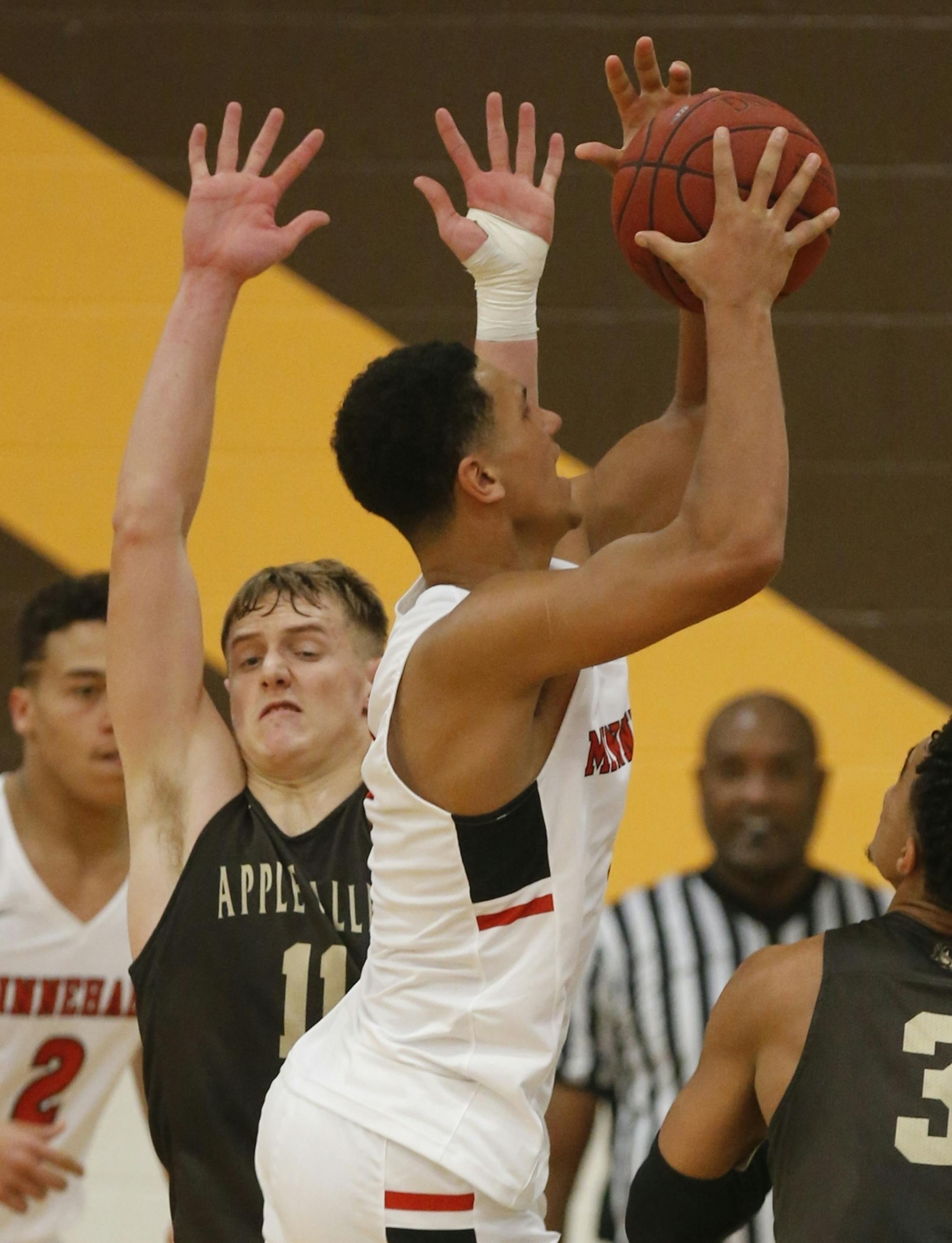 Jalen Suggs(1) went up for a shot against Luke Martens(11) of Apple Valley during the first half.