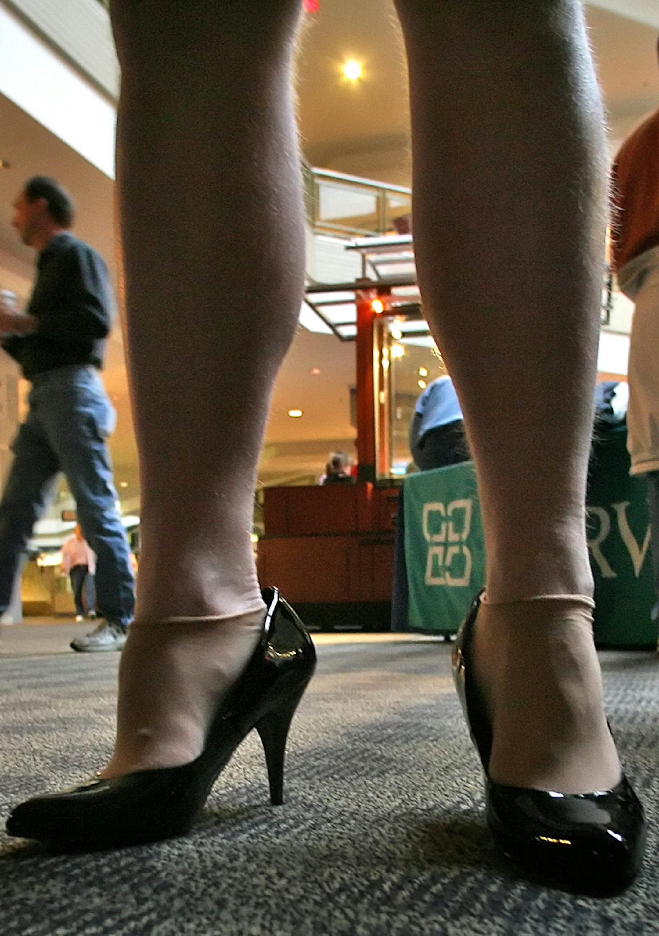 JIM GEHRZ Ô jgehrz@startribune.com Burnsville/April 19, 2008/8:30AM] Gary Owens, Minneapolis (feet, center) talked with others who had participated in the Walk A Mile In Her Shoes event held at Burnsville Center Saturday morning. Participants walked around a portion of the mall in high-heeled shoes, then gathered for refreshments and to look over informational materials on display. The walk was hosted by Fairview Ridges Hospital and the Sexual Assault Forensic Examiner Program to raise awar