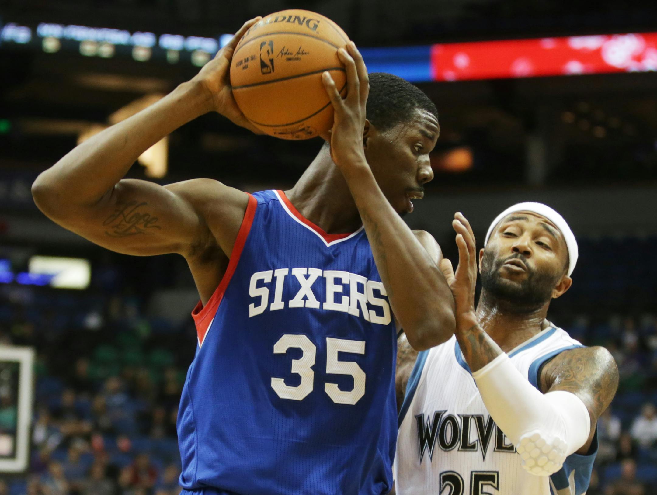 Philadelphia 76ers' Henry Sims, left, keeps an eye on Minnesota Timberwolves' Mo Williams in the second of an NBA preseason basketball game, Friday, Oct. 10, 2014, in Minneapolis. Williams led the Timberwolves with 19 points while Sims led the 76ers with 17 points. The Timberwolves won 116-110. (AP Photo/Jim Mone)