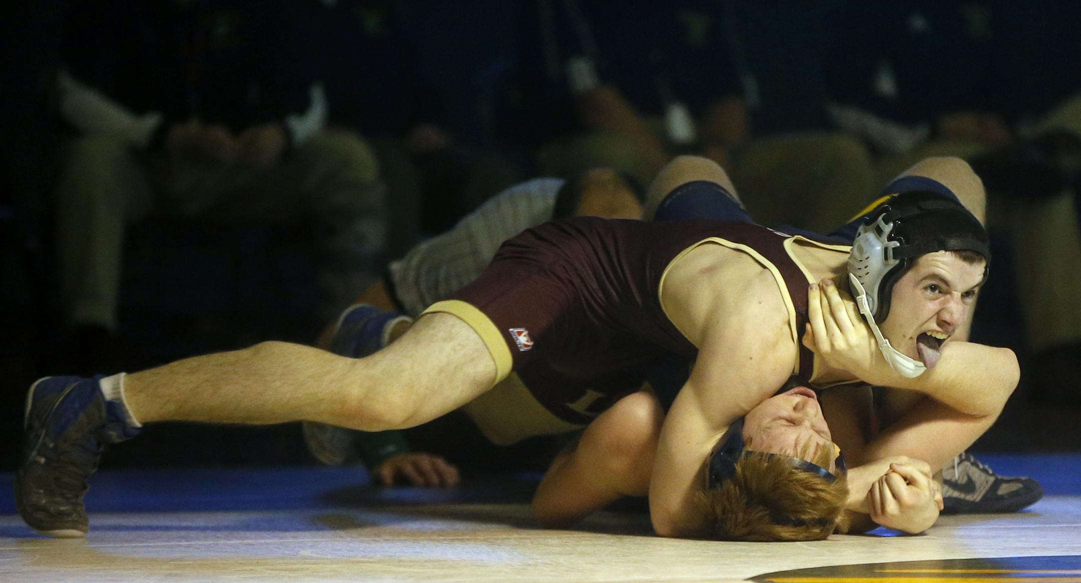 Lakeville South's Kayin Johnson turned Evan Sutherland to earn near-fall points during the Cougars' 48-27 victory. Lakeville South has its sights set on making the state tournament as a team. (Richard Tsong-Taatarii, Star Tribune)