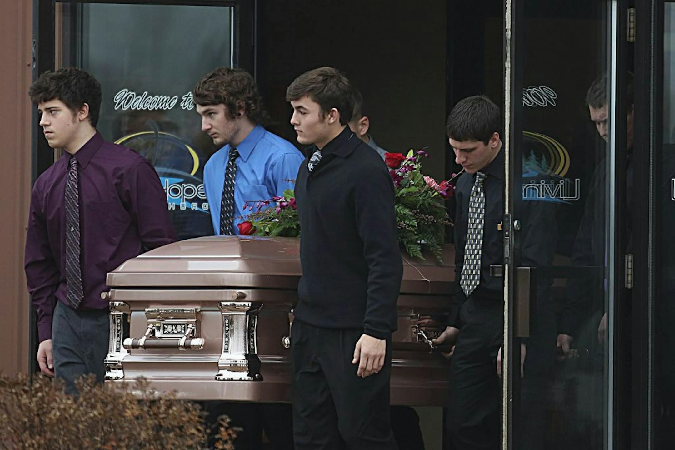 The remains of Haile Kifer were carried out of the church as mourners looked on.