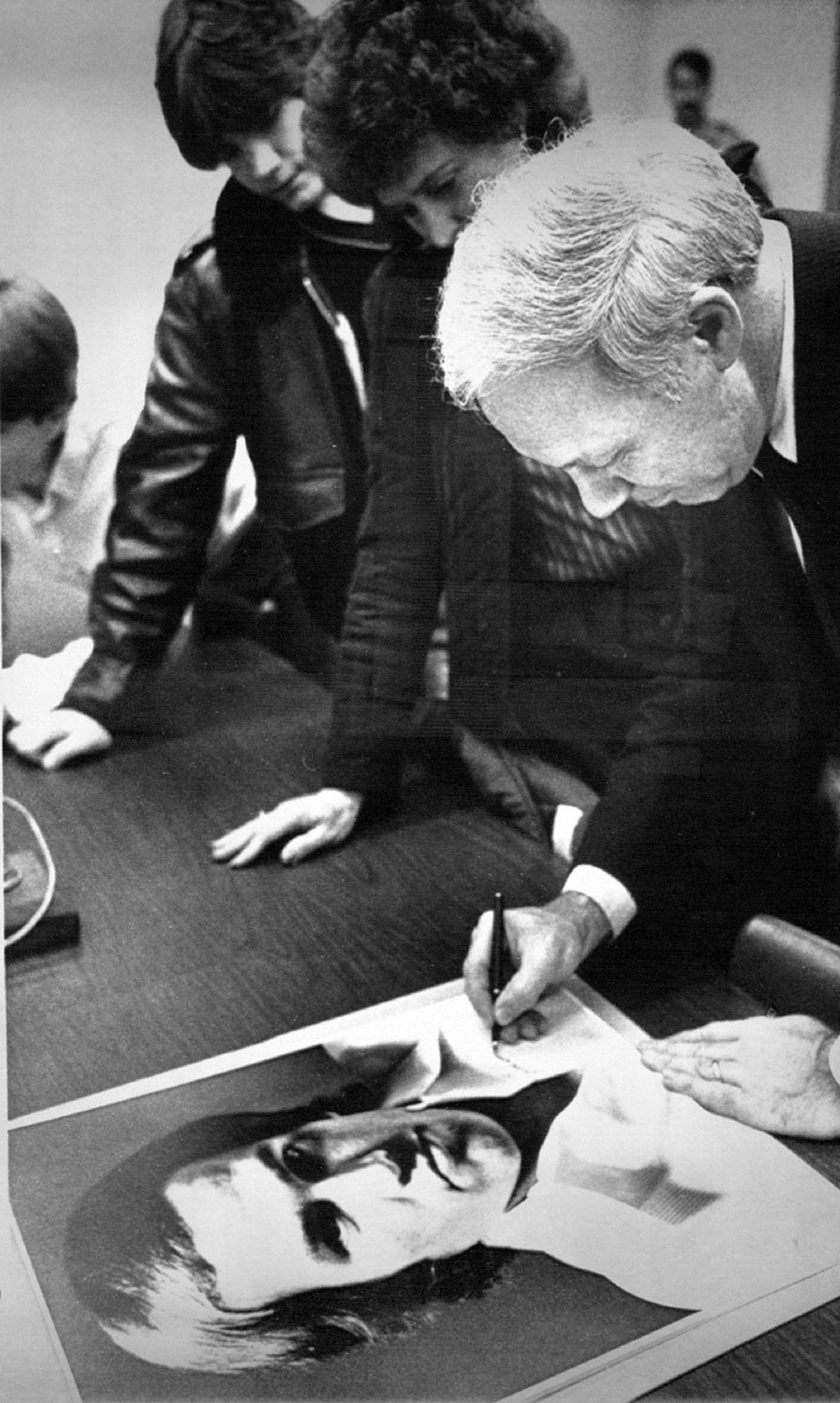 April 1, 1983 Autograph for T. J. - U.S. Rep. James Oberstar, D-Minn., autographs a large portrait of free-lance journalist Thomas (T. J. ) Western of St. Paul, Minn., Thursday. Oberstar aided in the release of Western and another journalist from a jail in El Salvador Wednesday. March 1983 Jim Mone, AP Laserphoto