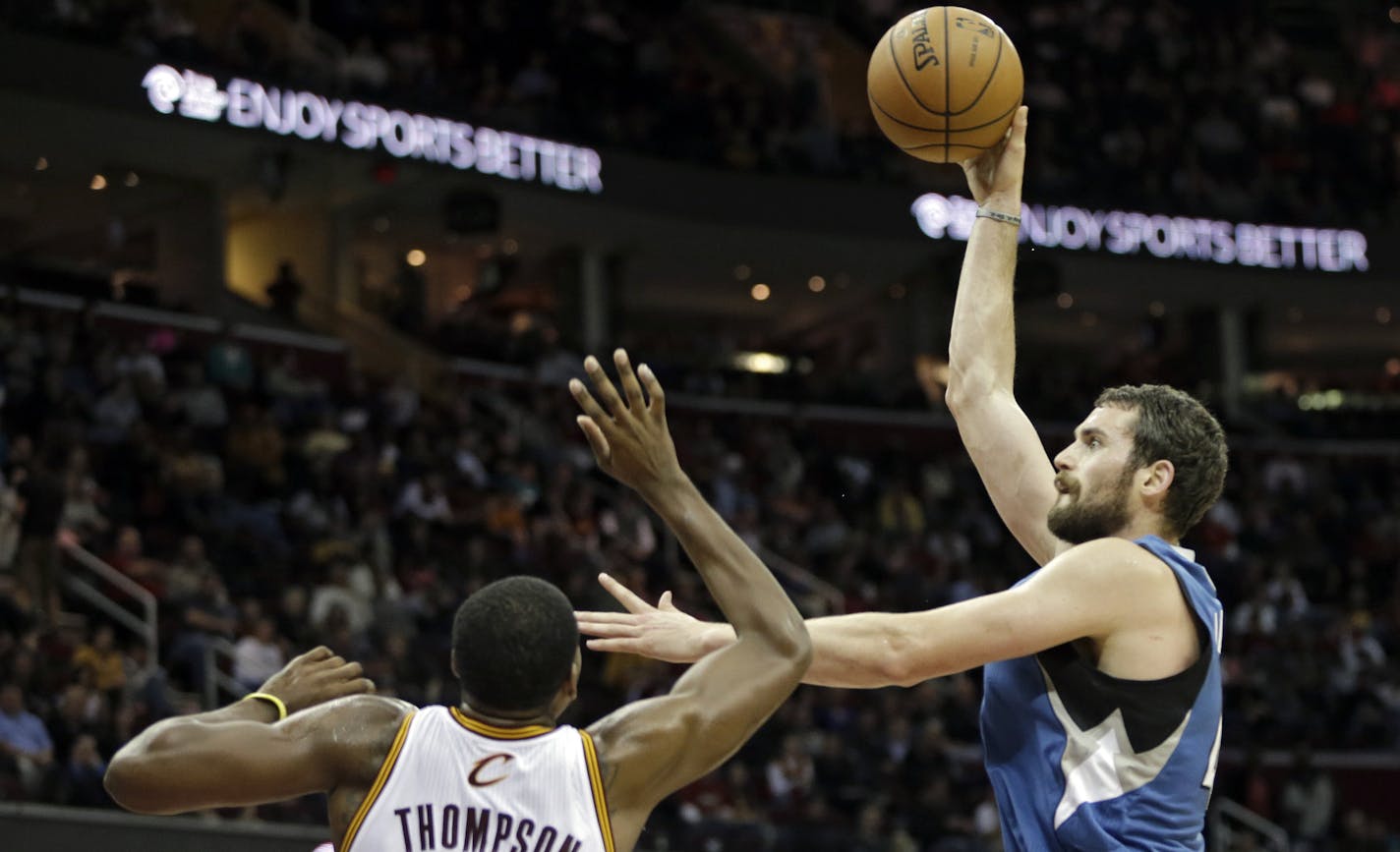 Minnesota Timberwolves' Kevin Love shoots over Cleveland Cavaliers' Tristan Thompson (13) in the third quarter of an NBA basketball game Monday, Nov. 4, 2013, in Cleveland. Love scored 17 points and grabbed 13 rebounds in the 93-92 loss to Cleveland. (AP Photo/Mark Duncan)