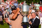 Xander Schauffele holds the Wanamaker trophy after winning the PGA Championship golf tournament at the Valhalla Golf Club, Sunday, May 19, 2024, in Lo