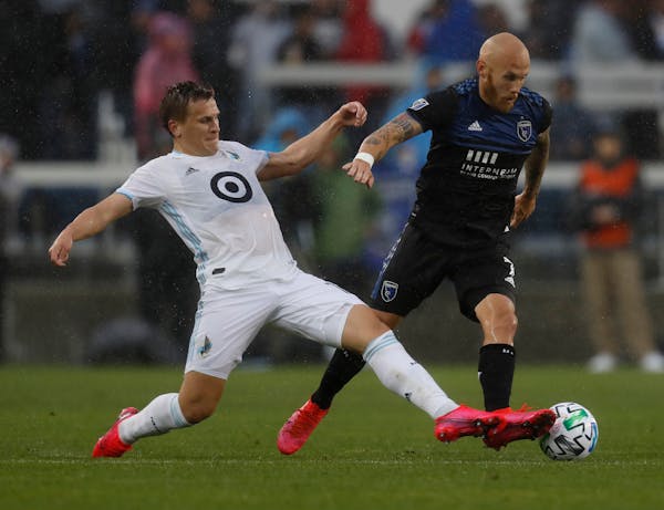 San Jose Earthquakes' Magnus Eriksson (7) keeps the ball away from Minnesota United FC's Robin Lod, left, in the first half of a game March 7.