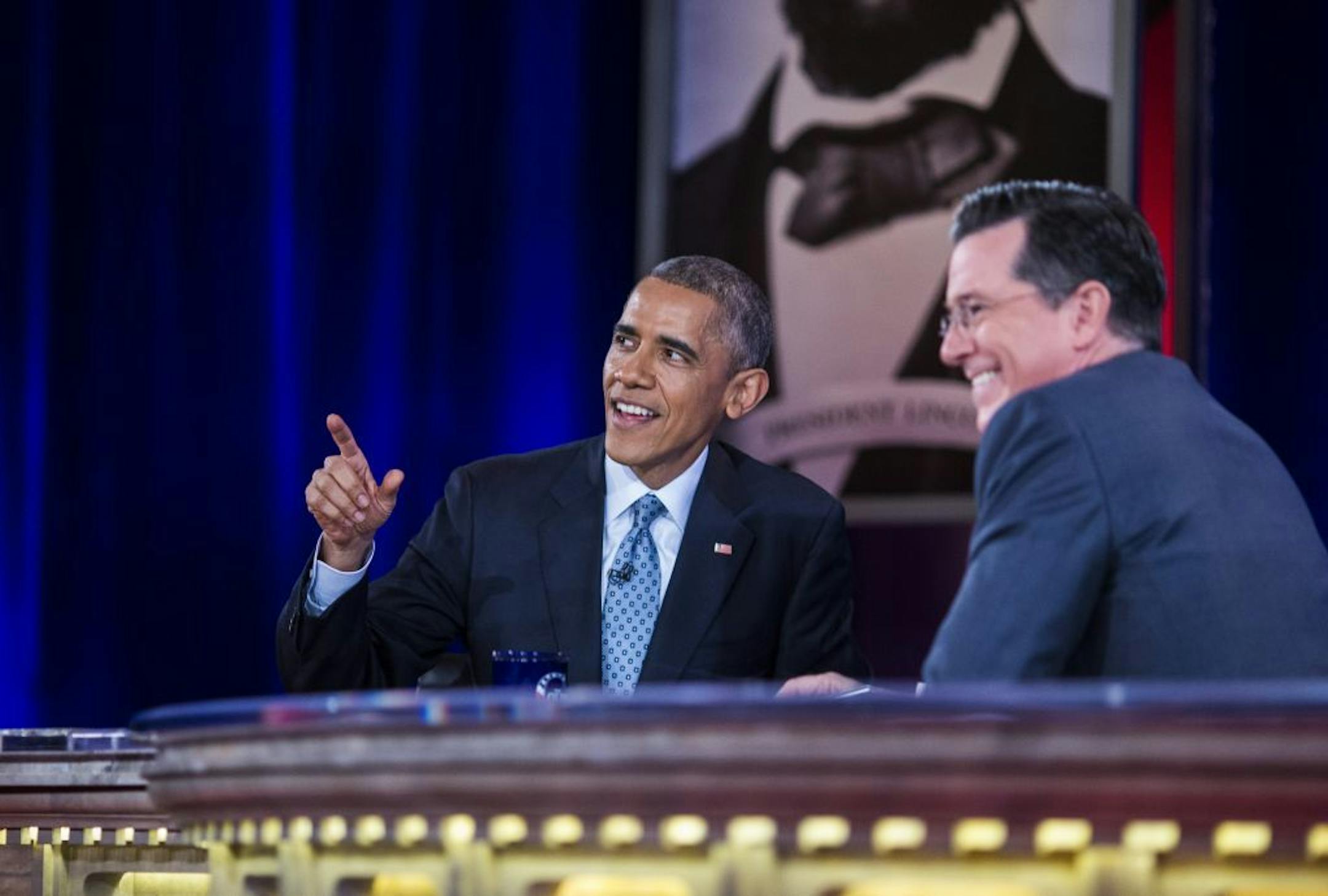 President Barack Obama talks with Stephen Colbert during recording of an upcoming epsiode of "The Colbert Report," Obama's third appearance on the show, in Lisner Auditorium at George Washington University in Washington, Dec. 8, 2014. The show's final episode is scheduled for Dec. 18, 2014, and Colbert will take over as host of "The Late Show," replacing David Letterman.