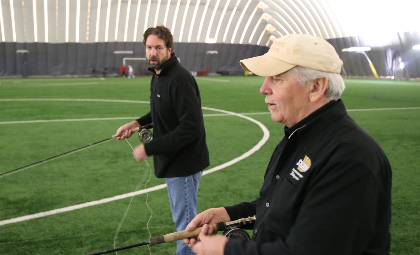 Mark Newman, left, of Hudson, Wis., cast a fly line in the dome at the St. Croix Valley Recreaton Center in Stillwater, tuning up with casting instructor Bob Nasby of St. Paul in anticipation of an upcoming saltwater fishing trip to the Florida Keys.