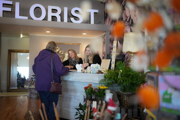Kelly Vranicar and Erika Kensinger helped a customer at Rosemount Floral by Lucky Lola in downtown Rosemount on Friday.