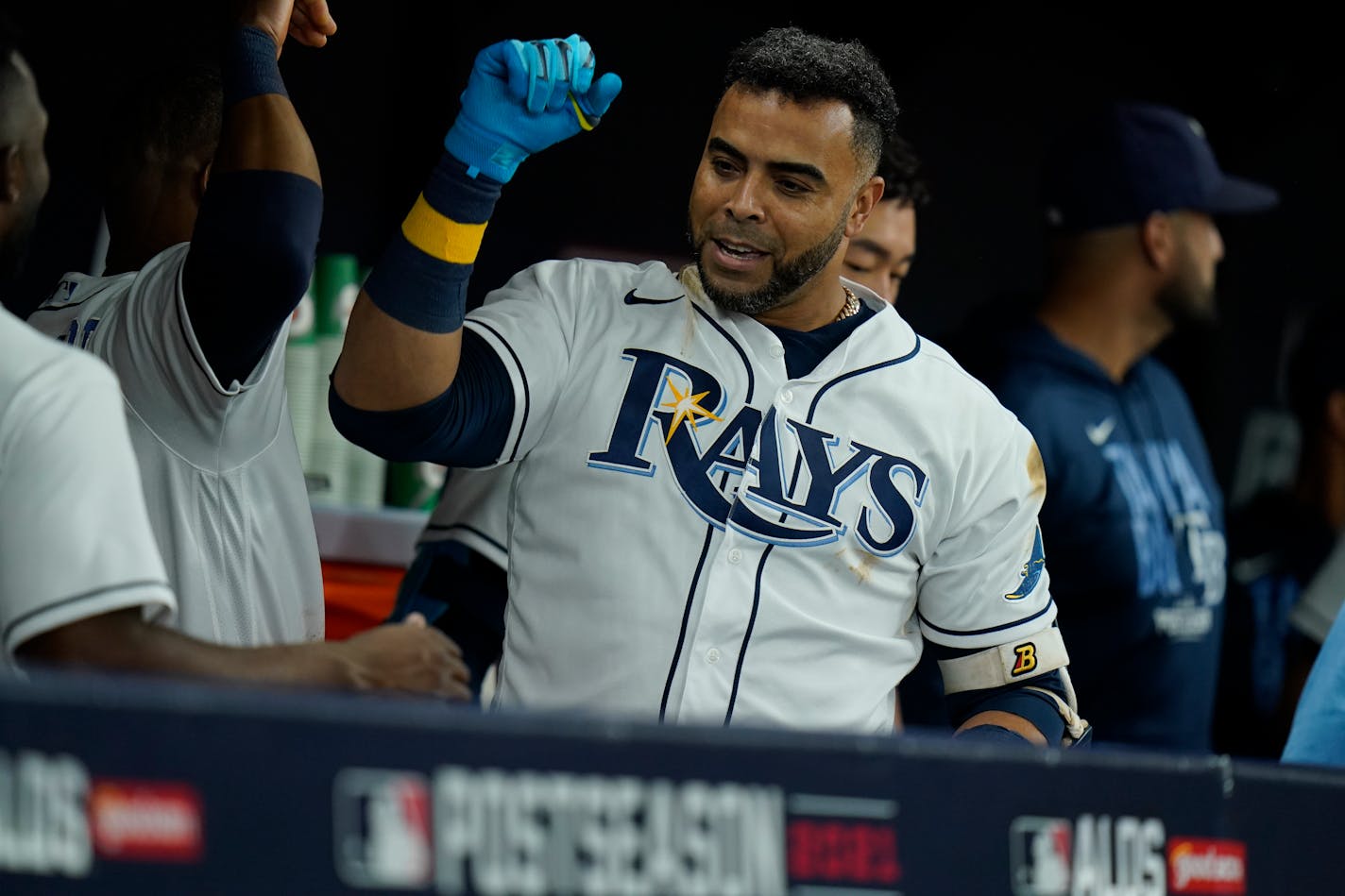 Tampa Bay Rays' Nelson Cruz gets hive fives in the dugout after hitting a home run against the Boston Red Sox in Game 1 of a baseball American League Division Series, Thursday, Oct. 7, 2021, in St. Petersburg, Fla. (AP Photo/Chris O'Meara)