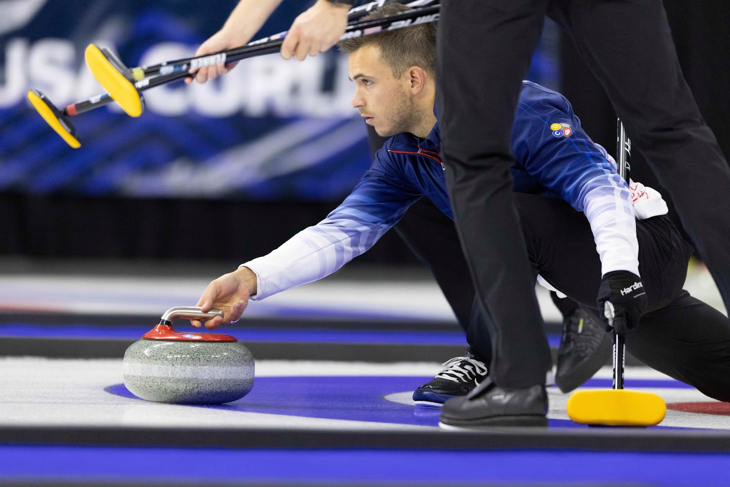 Team Dropkin's Korey Dropkin throws the rock while competing against Team Shuster during the first night of finals at the U.S. Olympic Curling Team Trials at Baxter Arena in Omaha, Neb., Friday, Nov. 19, 2021. (AP Photo/Rebecca S. Gratz)