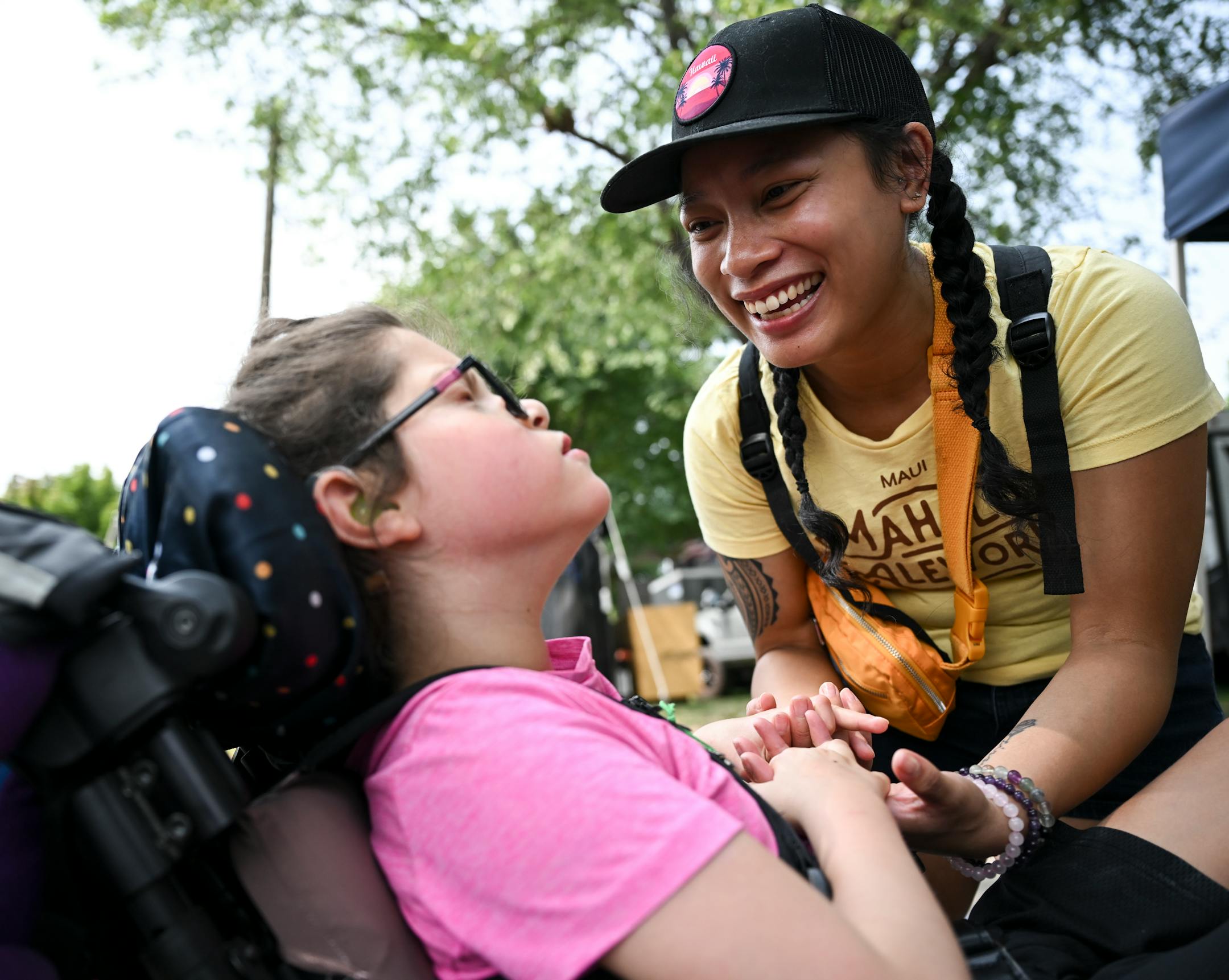 Rodessa Johnson, with DeafBlind Services Minnesota, gently wakes up Sadie Sava, 8, after they used the fair's adult changing table.