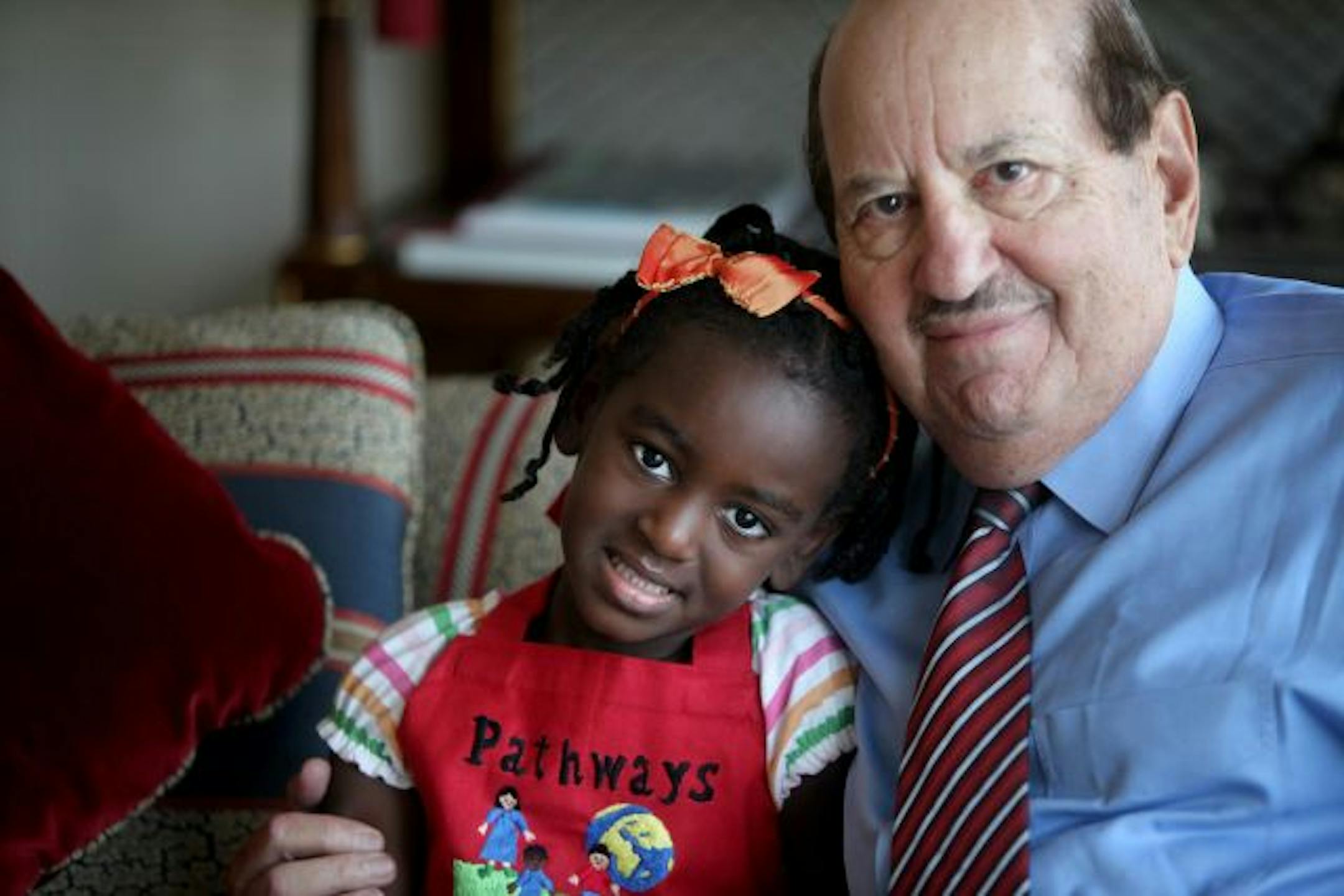 Ralph Strangis hugged Eva Ieronimo at his Minneapolis home during a recent visit. Strangis was part of Pathways to Children, a group that cared for Eva in Ethiopia before Christine Ieronimo came to adopt her. Ieronimo brought Eva to the Twin Cities this month for a reunion with Strangis.