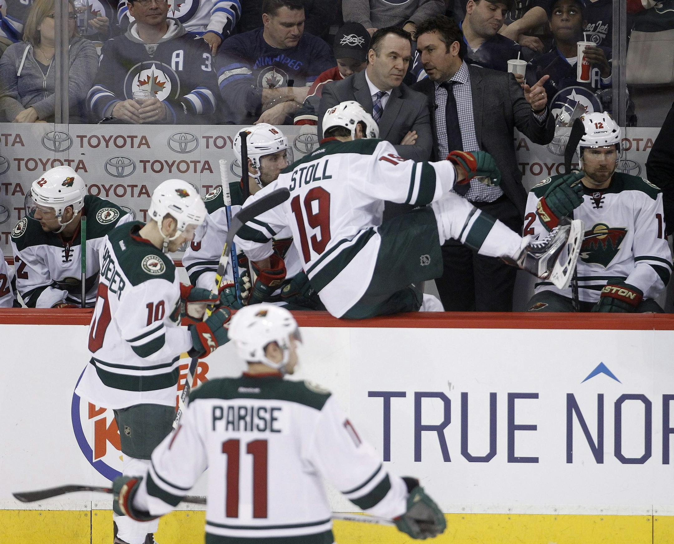 Minnesota Wild's head coach John Torchetti, top centre, confers with coaching staff during third period NHL hockey action against the Winnipeg Jets' in Winnipeg, Sunday, April 3, 2016. (Trevor Hagan/The Canadian Press)