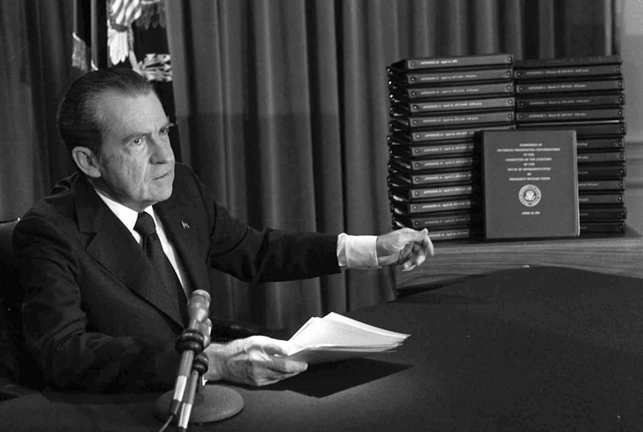 FILE - In this April 29, 1974, file photo, President Richard M. Nixon points to the transcripts of the White House tapes after he announced during a nationally-televised speech that he would turn over the transcripts to House impeachment investigators, in Washington.