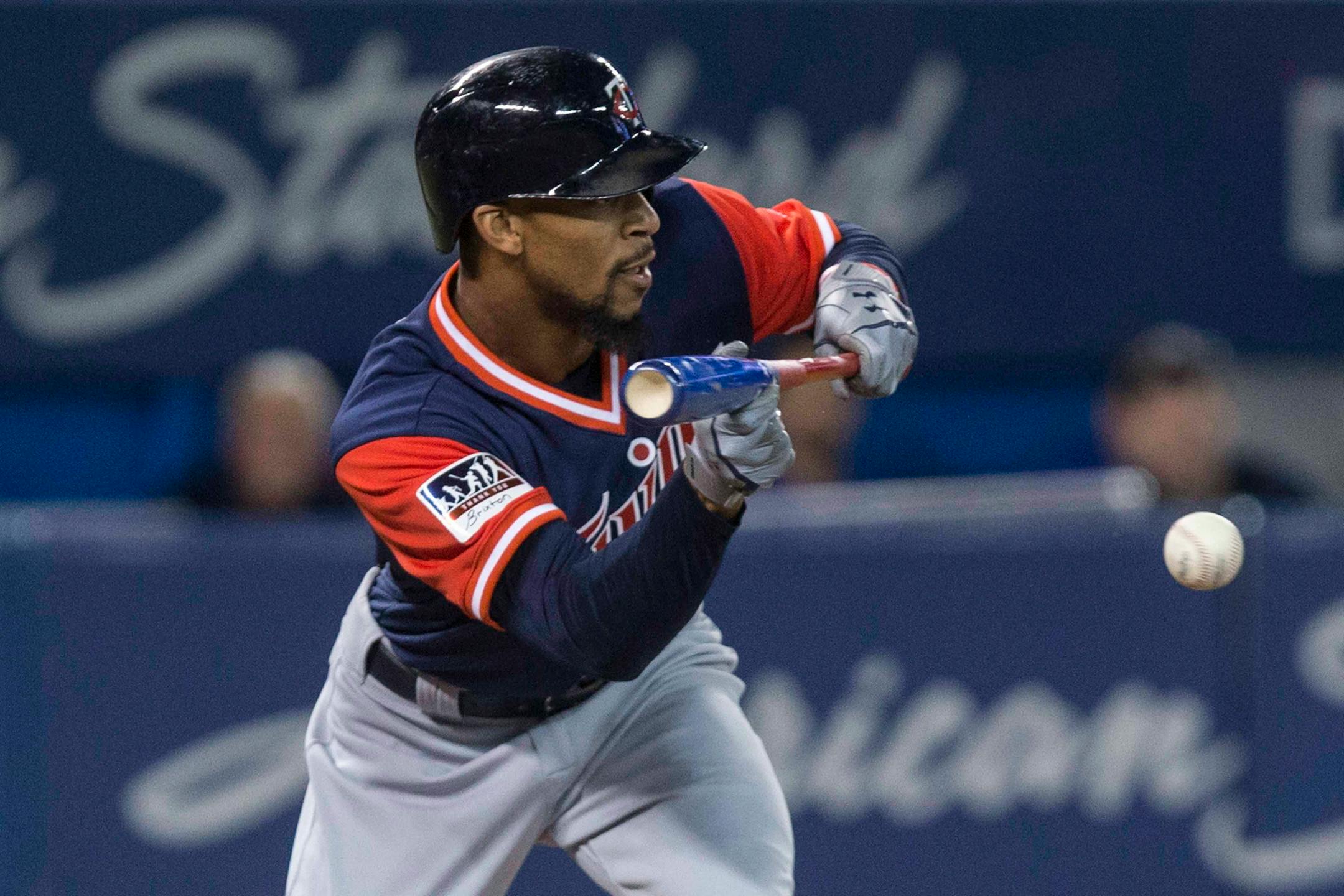 Minnesota Twins' Byron Buxton bunts for a single off Toronto Blue Jays pitcher J.A. Happ during the fifth inning of a baseball game Friday, Aug. 25, 2017, in Toronto. (Chris Young/The Canadian Press via AP)