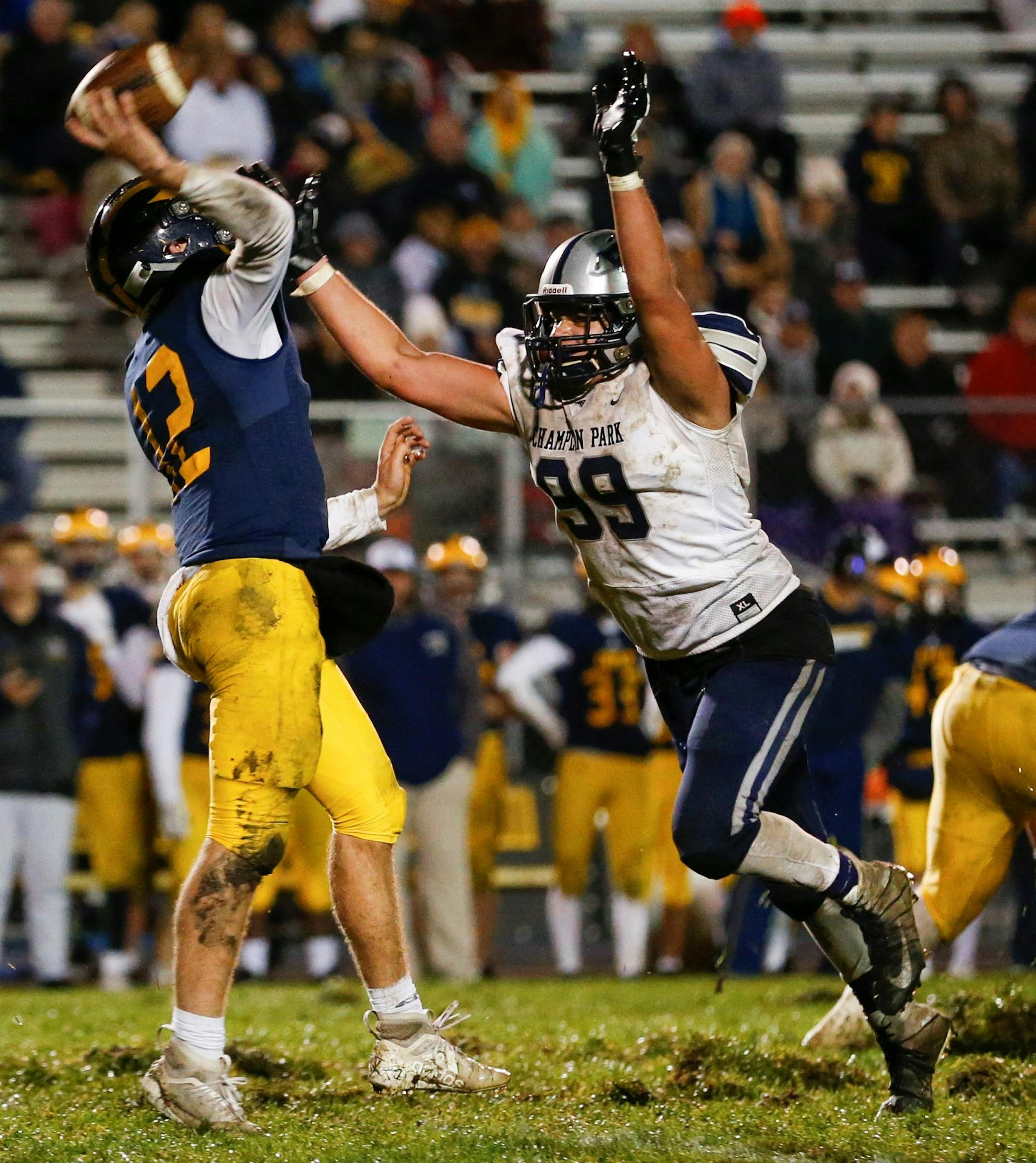 Champlin Park's Sam Knutson (99) applies pressure to Rosemount quarterback Trevor Armborst (12) Friday night in Rosemount. The Rebels defense led the way in their 17-14 victory over the Irish. Photo by Jeff Lawler, SportsEngine