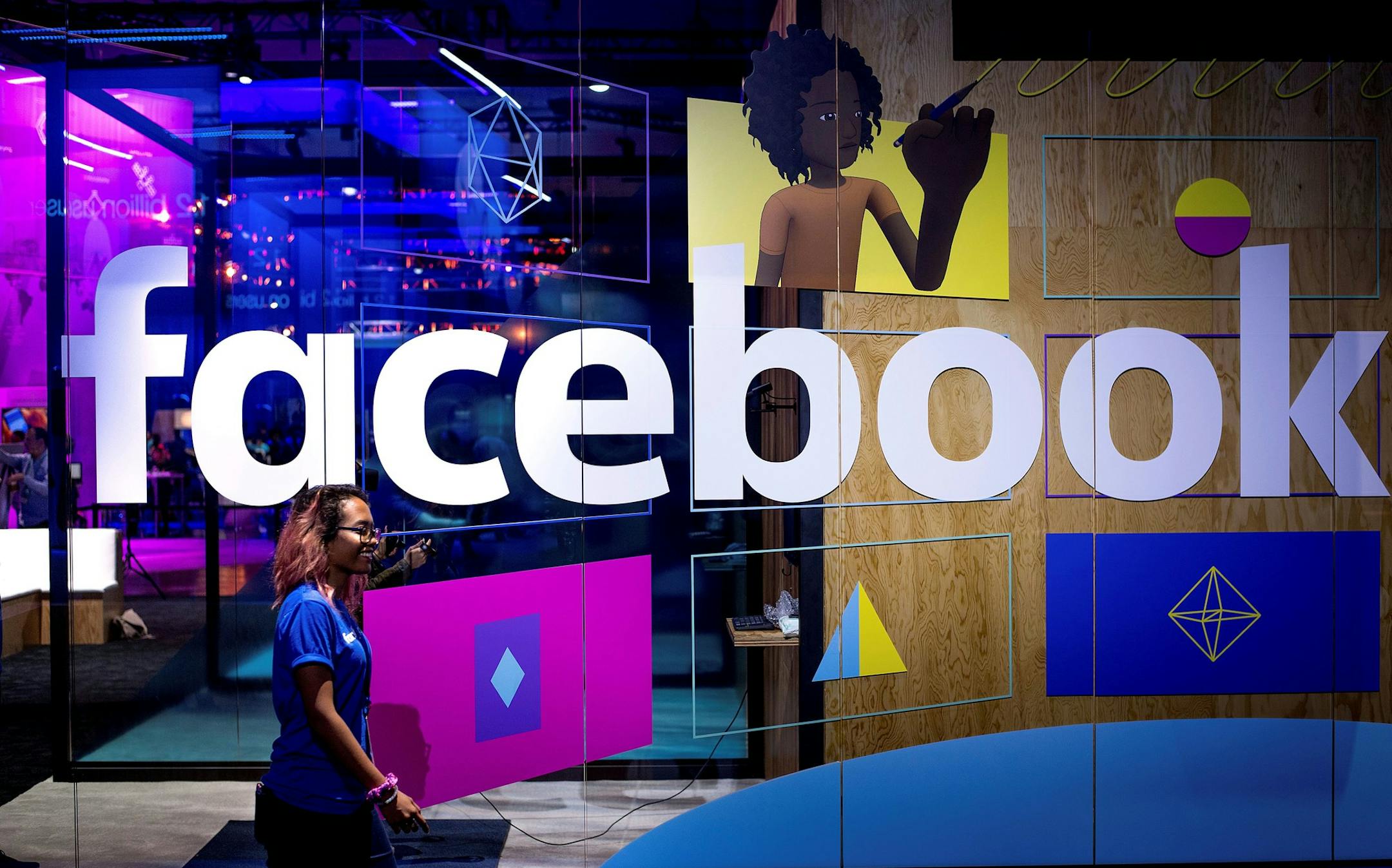 FILE - In this Tuesday, April 18, 2017, file photo, a conference worker passes a demo booth at Facebook's annual F8 developer conference, in San Jose, Calif. Technology companies are on track to reach all-time highs soon, and Facebook is one of the most valuable companies on the U.S. stock market today. (AP Photo/Noah Berger, File) ORG XMIT: NYBZ532