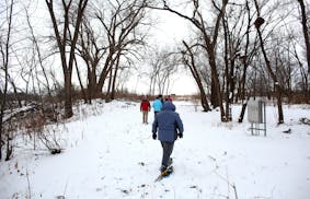 A group of snowshoe hikers headed out along the Mississippi River.