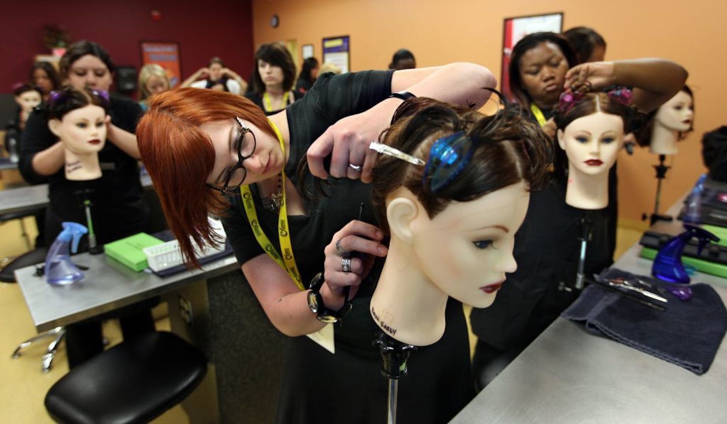 Students at a beauty school practiced techniques on mannequins.