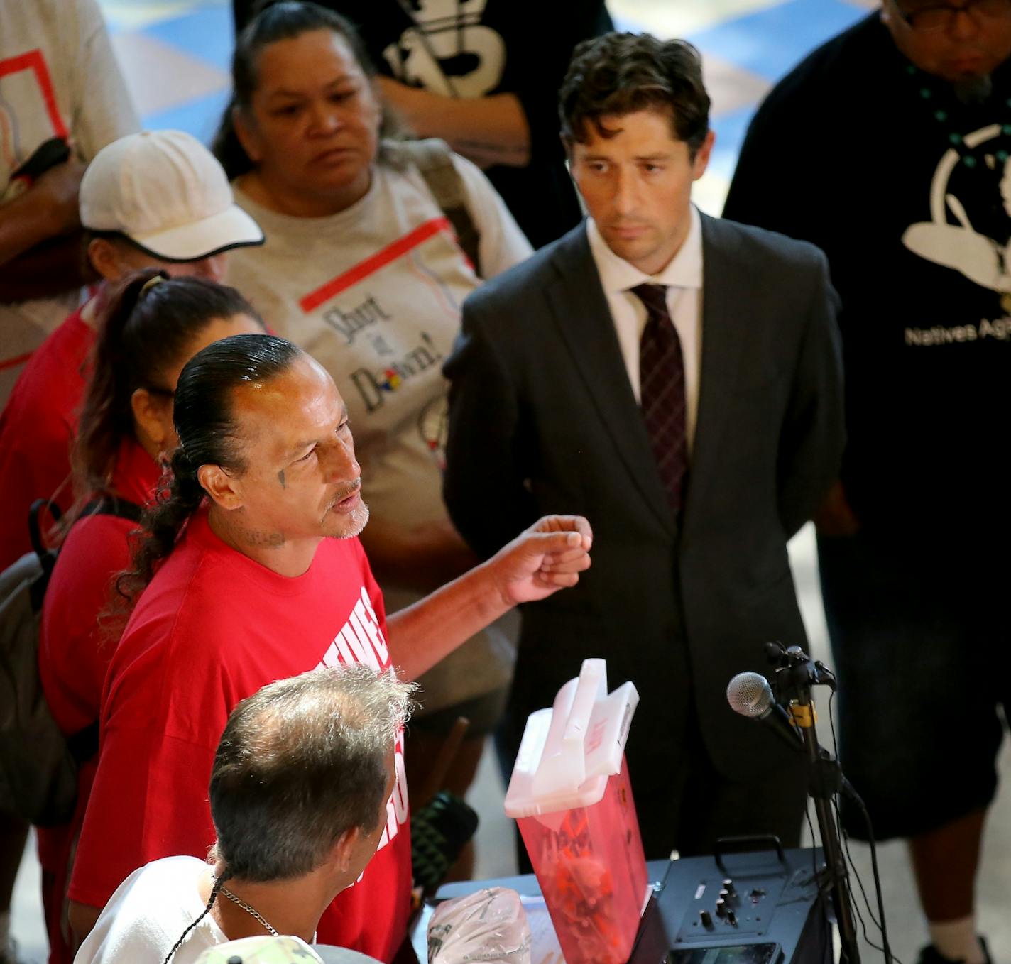 Mayor Jacob Frey and leaders from the American Indian community, among others, will outline their plan to assist people living in a homeless encampment near Hiawatha and Cedar Avenues in south Minneapolis. The encampment of mostly American Indians has grown rapidly in size, raising health and safety concerns. Here, James Cross, founder of Natives Against Heroin, spoke at the gathering as Mayor Jacob Frey listened Thursday, Aug. 23, 2018, at the Minneapolis American Indian Center in Minneapolis,