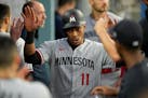 Minnesota Twins' Jorge Polanco (11) celebrates in the dugout after scoring off of a single by Kyle Farmer during the second inning of a baseball game 
