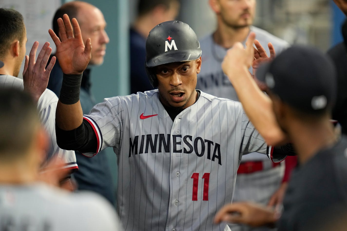 Minnesota Twins' Jorge Polanco (11) celebrates in the dugout after scoring off of a single by Kyle Farmer during the second inning of a baseball game against the Los Angeles Dodgers in Los Angeles, Monday, May 15, 2023. (AP Photo/Ashley Landis)