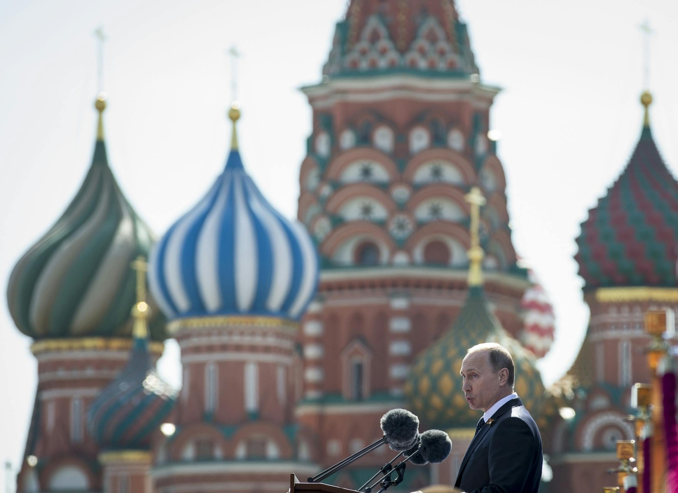 Russian President Vladimir Putin addresses the Victory Parade marking the 70th anniversary of the defeat of the Nazis in World War II, in Red Square, Moscow, Russia, Saturday, May 9, 2015, with the St. Basil's Cathedral is in the background.