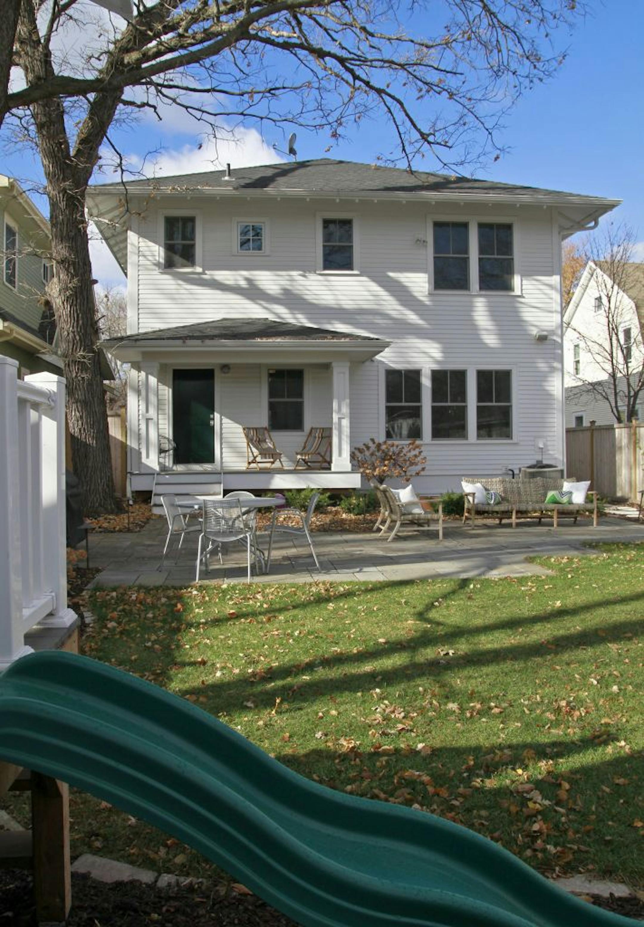 Family friendly design - rear exterior with childs play area, patio and porch of the Linden Hills home featured on HGTV. Mekea Duffy.