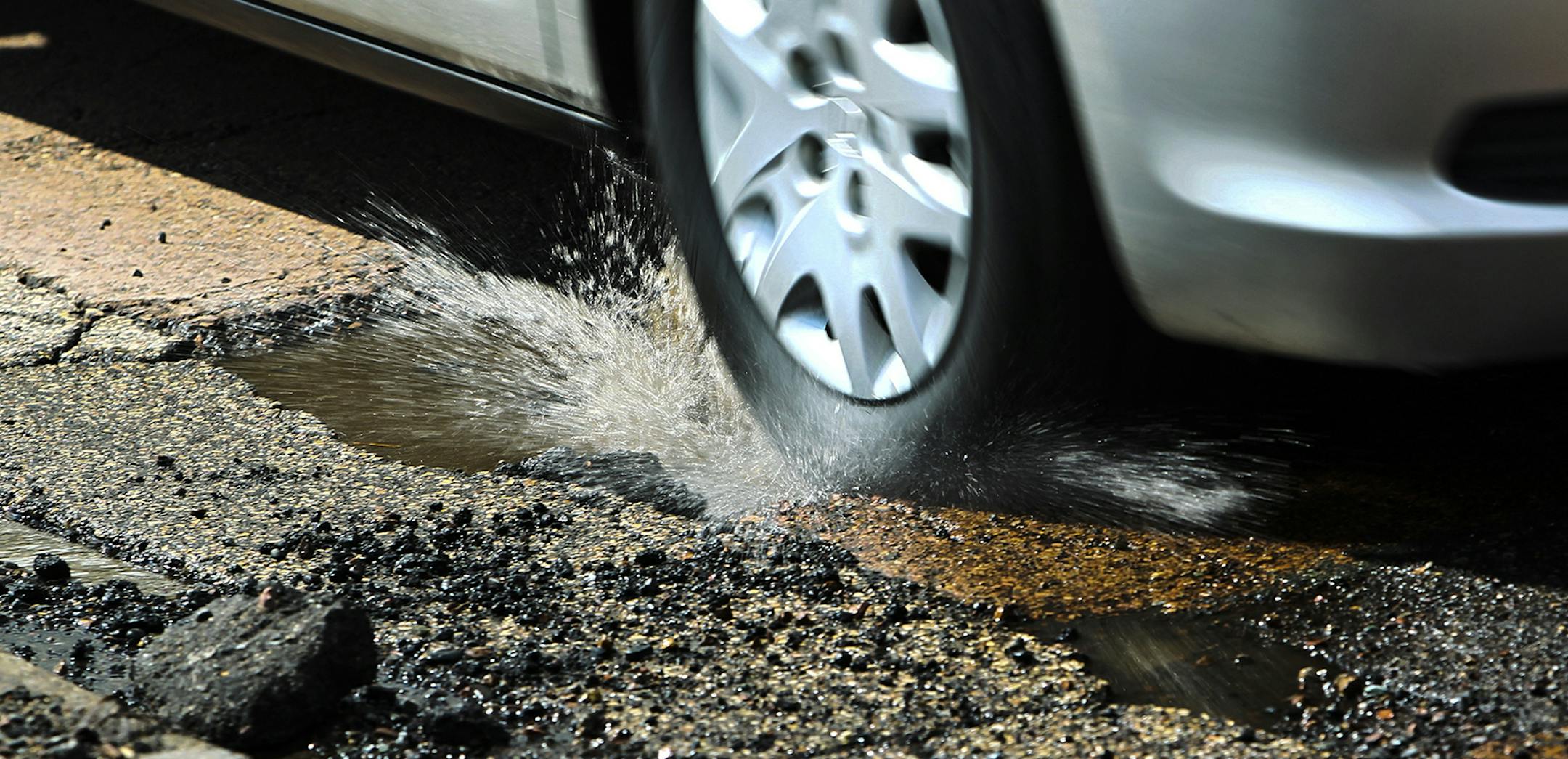 Cars driving on E. Minnehaha Parkway along Lake Nokomis tried to dodge potholes.