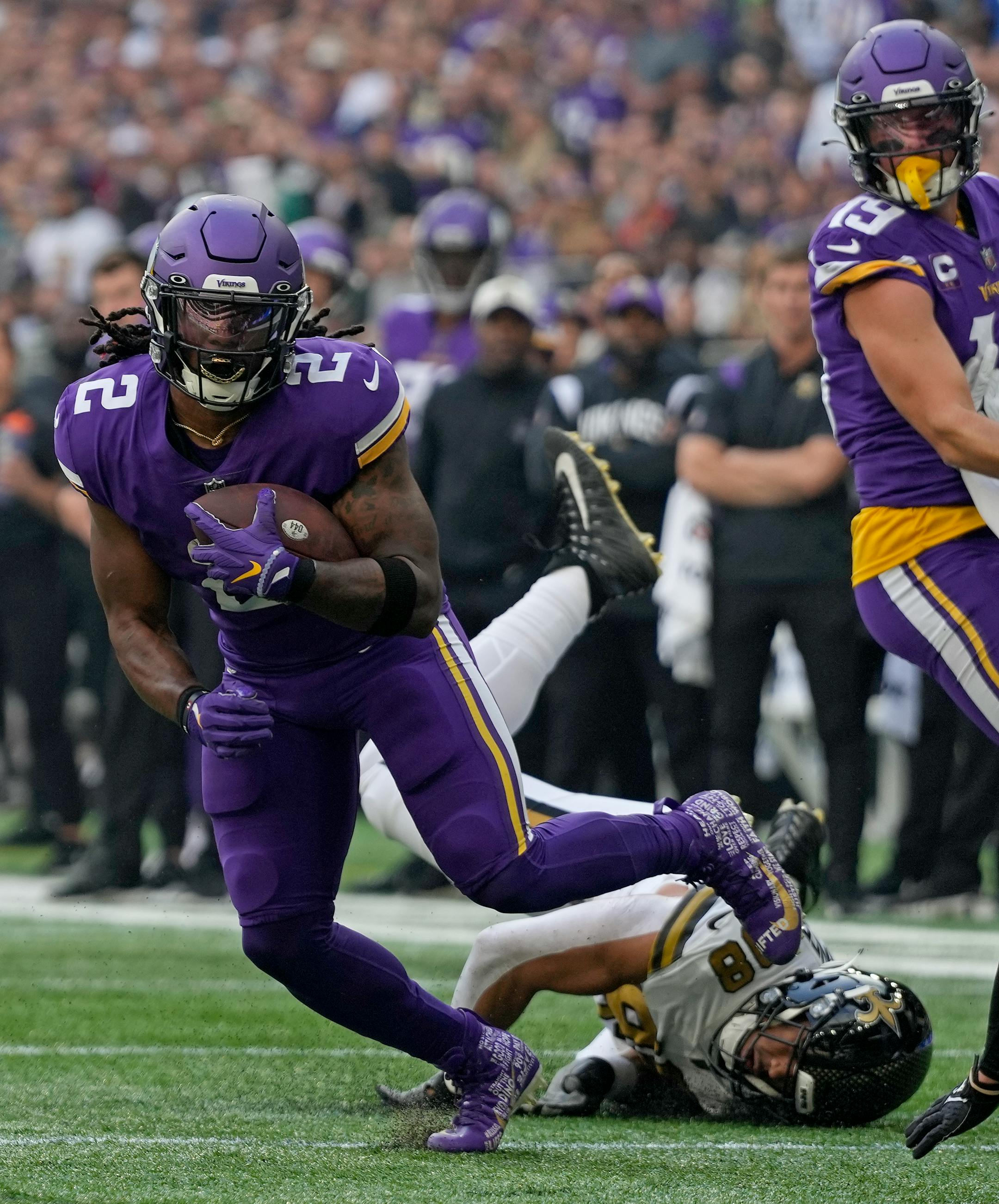 Minnesota Vikings running back Alexander Mattison (2) breaks a tackle to score a touchdown in the first quarter of an NFL match between Minnesota Vikings and New Orleans Saints at the Tottenham Hotspur stadium in London, Sunday, Oct. 2, 2022. (AP Photo/Frank Augstein)