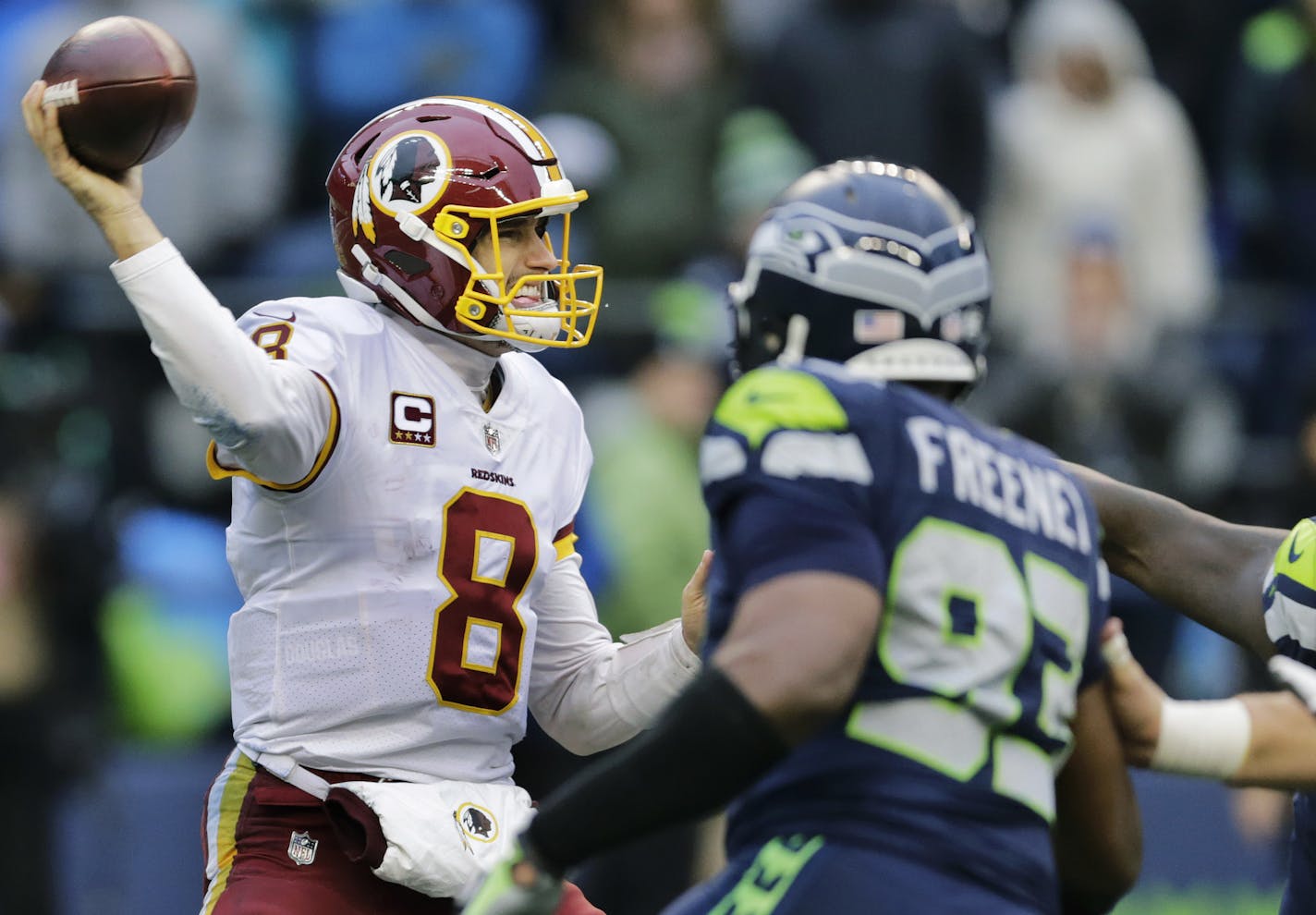 Washington Redskins quarterback Kirk Cousins passes under pressure from Seattle Seahawks defensive end Dwight Freeney (93) in the second half of an NFL football game, Sunday, Nov. 5, 2017, in Seattle. (AP Photo/Stephen Brashear)