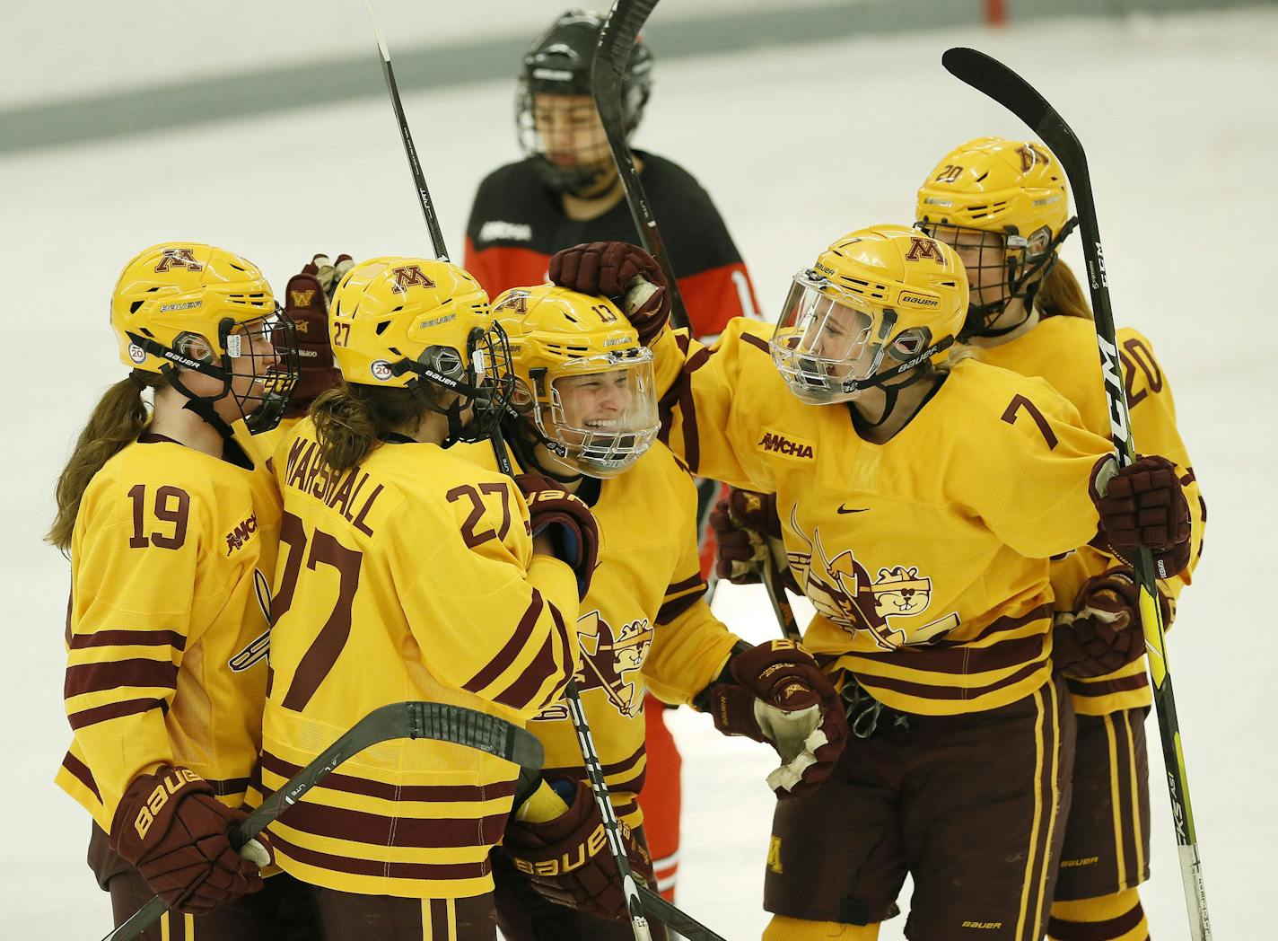 Gophers teammates, including Kelly Pannek (19), Taylor Williamson (7), Patti Marshall (27) and Alex Woken (20), congratulate Crystalyn Hengler (13) after she scored a goal against Ohio State last month.