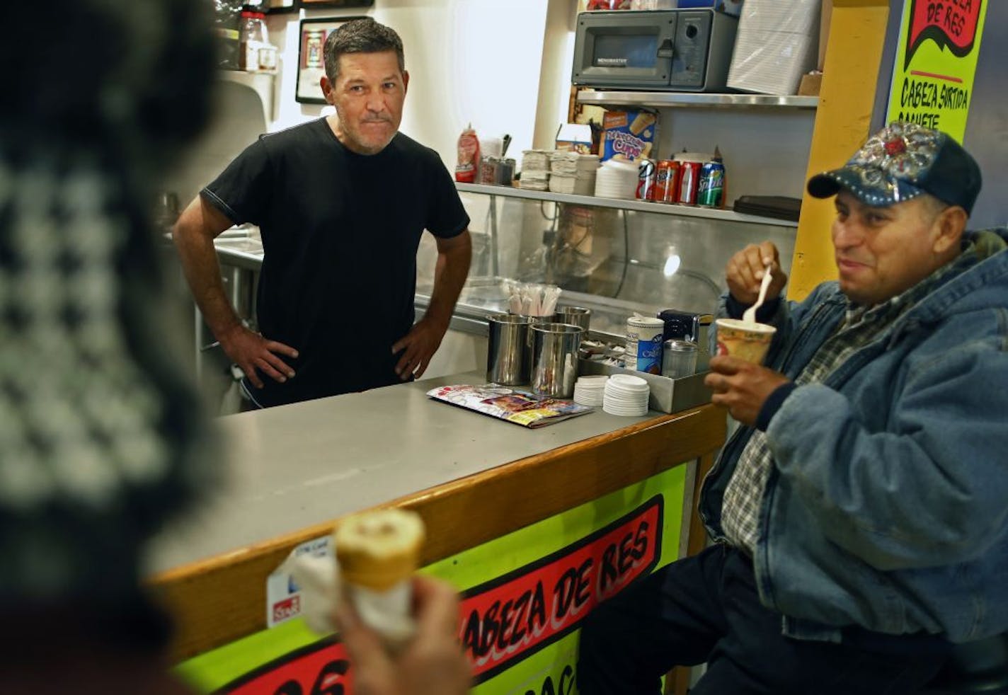 At El Cafe in the Mercado Central, owner Ernesto Payan, center, chatted with customers Antonio Gachuzo, left, and Victor Delgado, right.