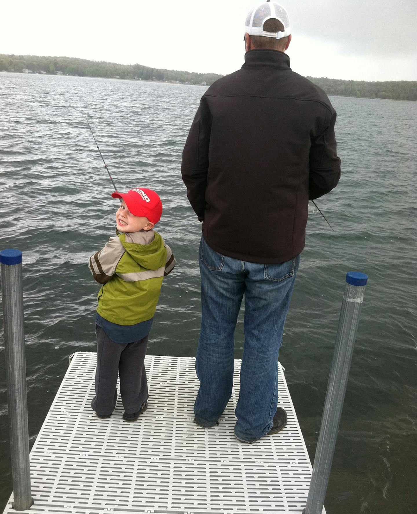 Professional angler and guide Tony Roach with his son, Robbie. The younger Roach is learning to fish from a dock, like his dad did as a kid. That's where Robbie's great-great uncle and famous walleye angler Gary Roach first fished, too.